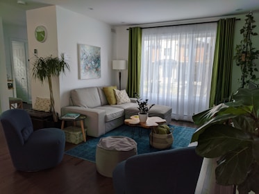 a living room filled with furniture and a large window