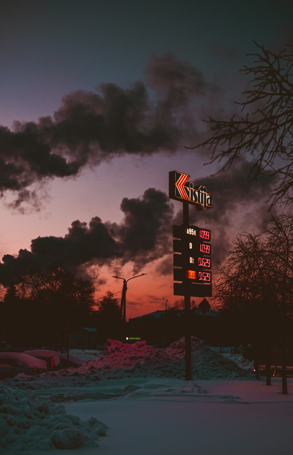 a street sign on a pole in the snow