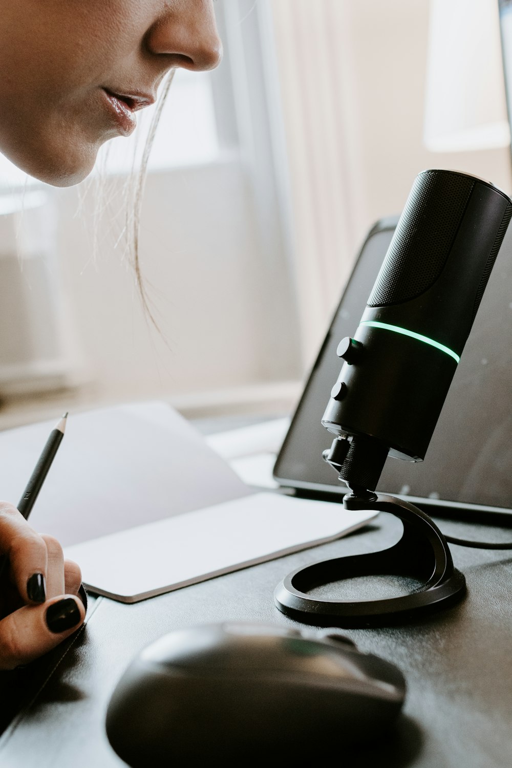 person holding black and green portable speaker