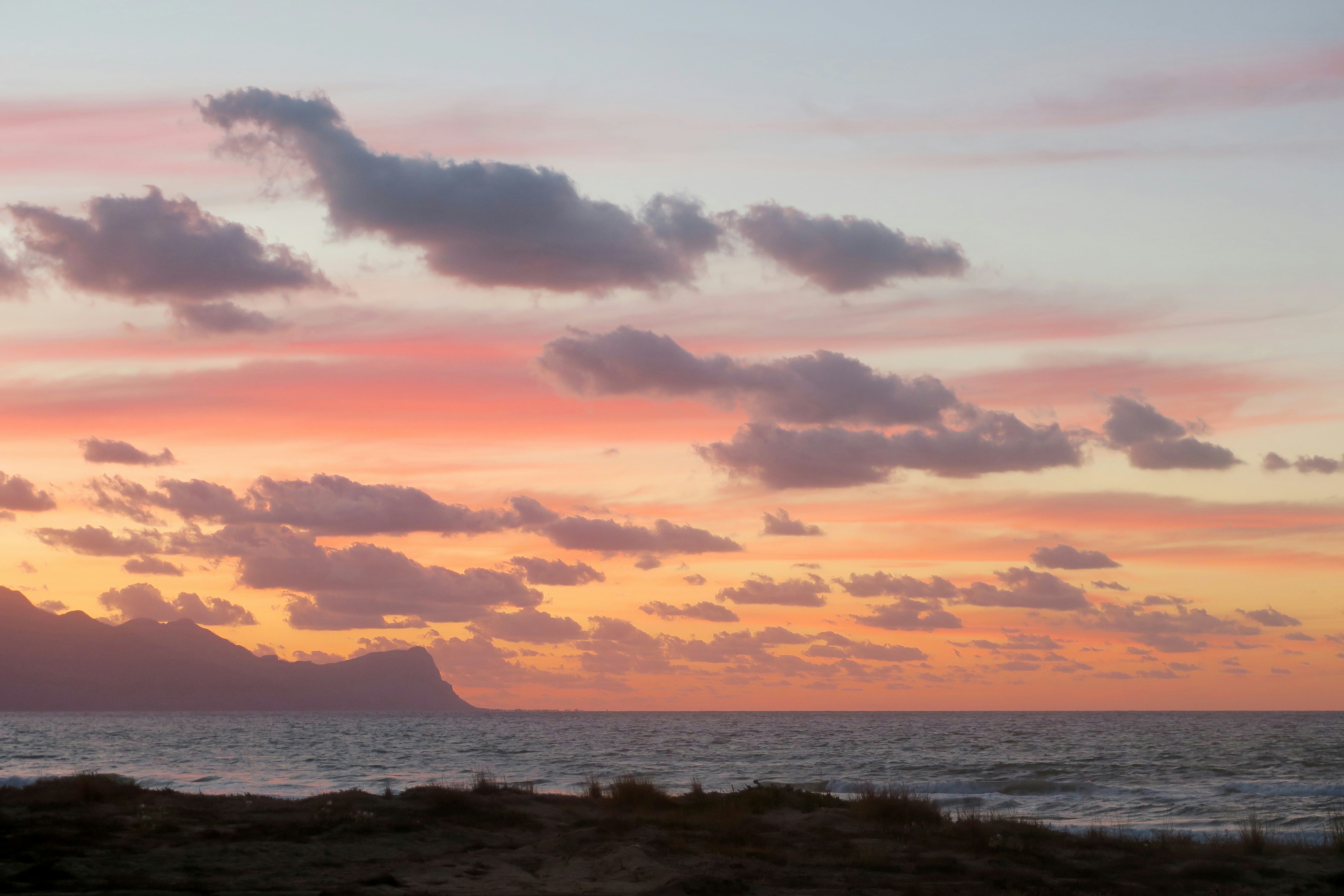 body of water under cloudy sky during sunset, 