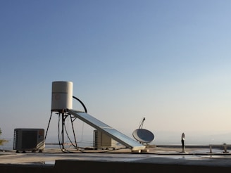 white satellite dish on gray concrete floor during daytime