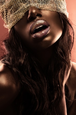 Artistic shot of a silk blindfold resting on smooth skin.