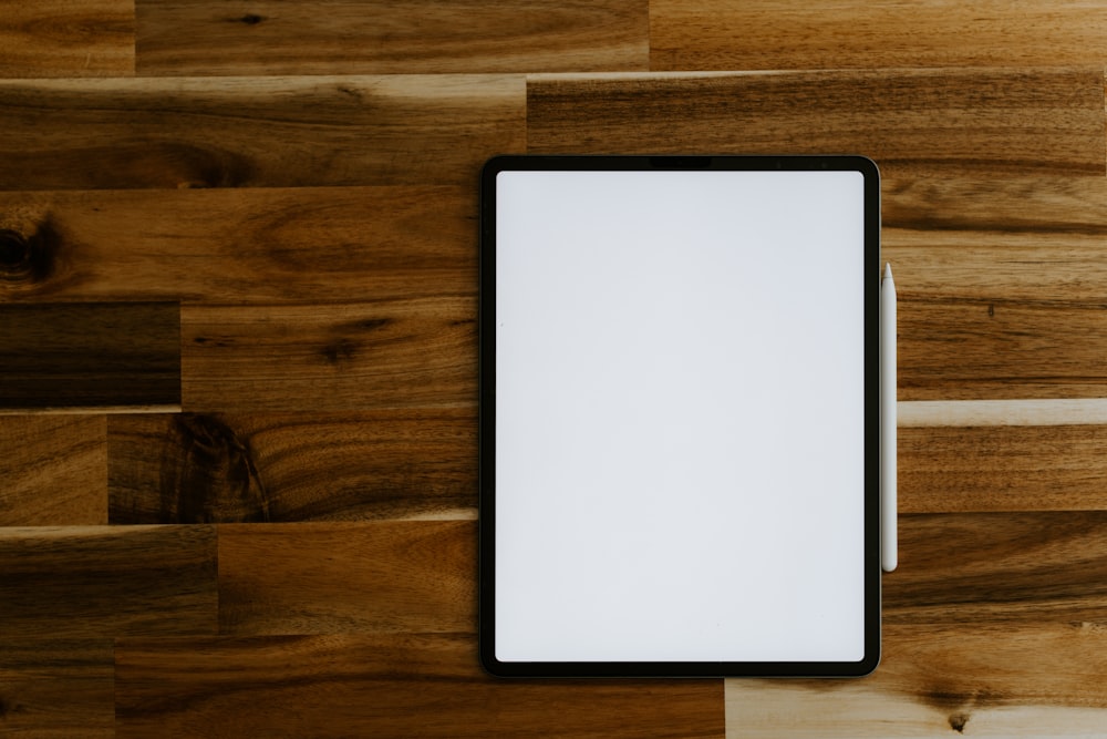 white rectangular frame on brown wooden table