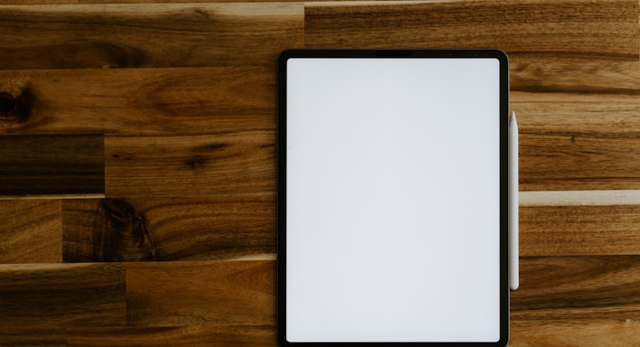 white rectangular frame on brown wooden table