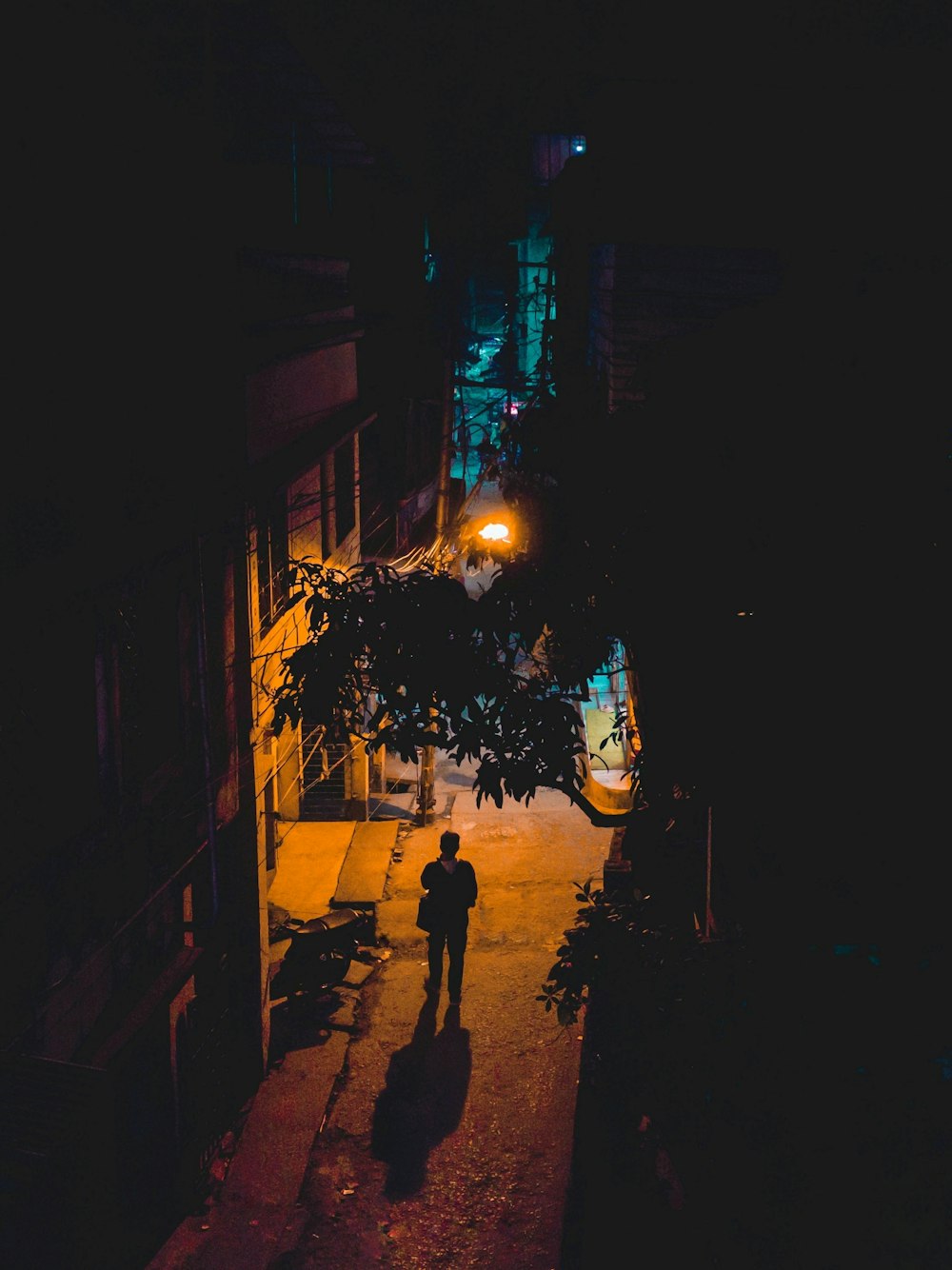 man and woman walking on street during night time