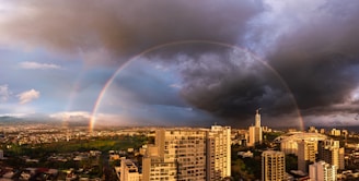 A vibrant rainbow arching across the sky after a brief monsoon rain.