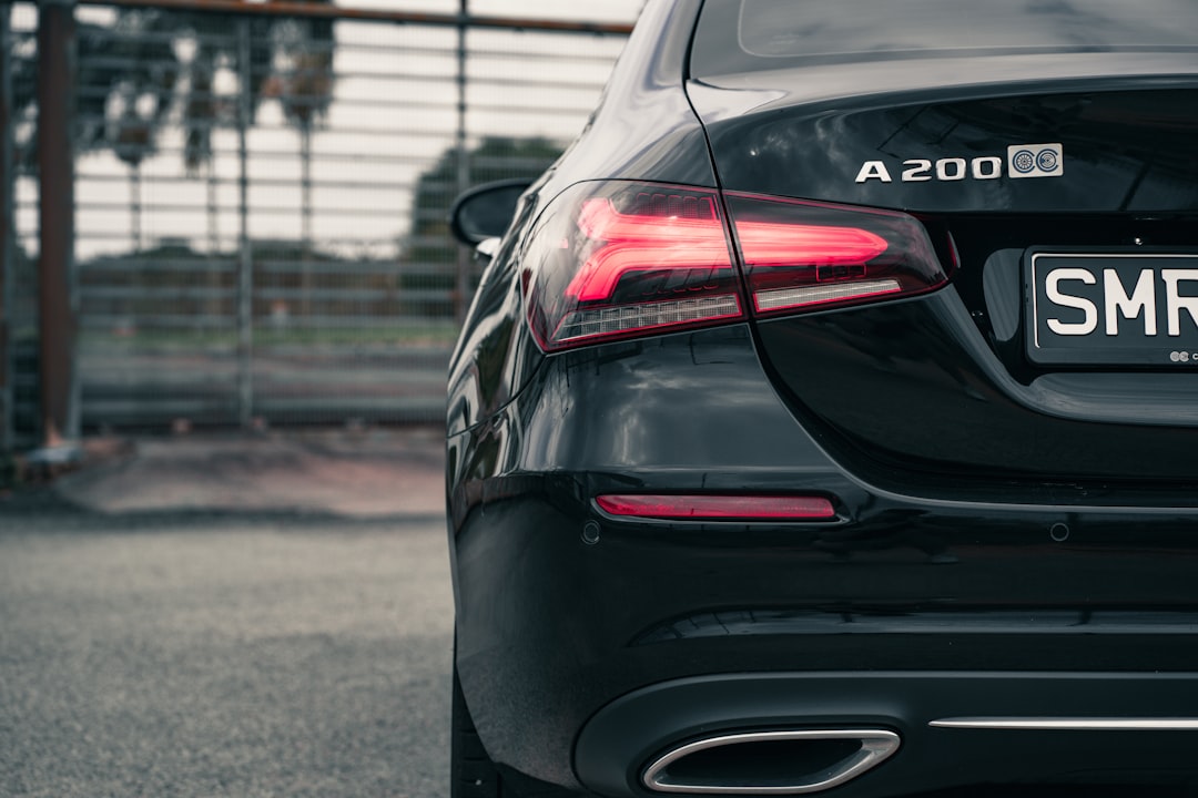 black car on gray asphalt road during daytime