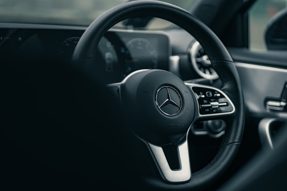 black and silver mercedes benz steering wheel