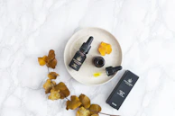 An artful flat lay of various THC products including edibles, oils, and flower jars on a rustic wooden table.