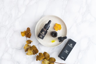 An inviting flat lay of Australian peptide bottles with native eucalyptus leaves on a wooden surface.
