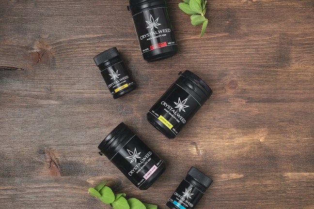 Close-up of a pink-themed display with colorful weed disposables neatly arranged.