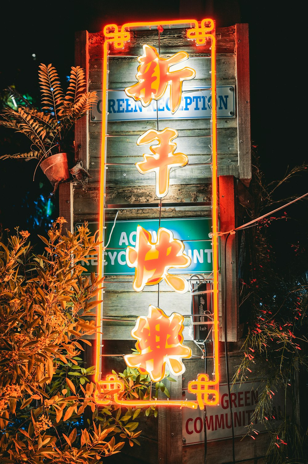 a neon sign is lit up on the side of a building