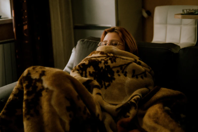 Soft blanket and journal on a couch