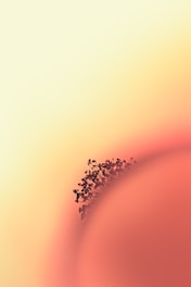 A close-up view of a spherical structure with tiny, branching elements protruding from its surface, against a soft gradient background of warm colors.