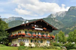 Chalet exterior framed by blooming wildflowers and vibrant greenery.