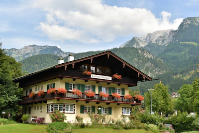 Chalet exterior framed by blooming wildflowers and vibrant greenery.