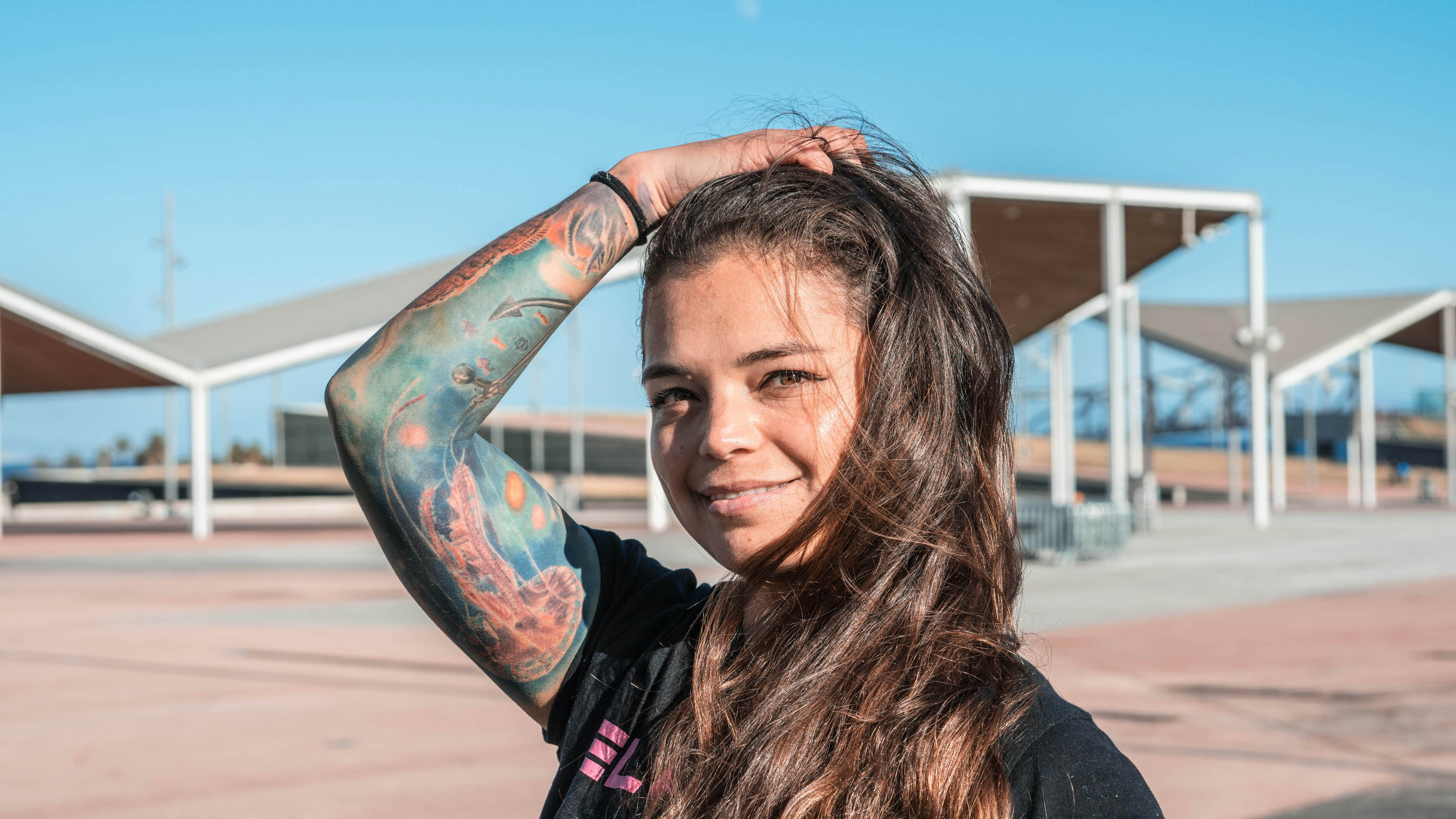 woman in black jacket with blue and black body paint on her face