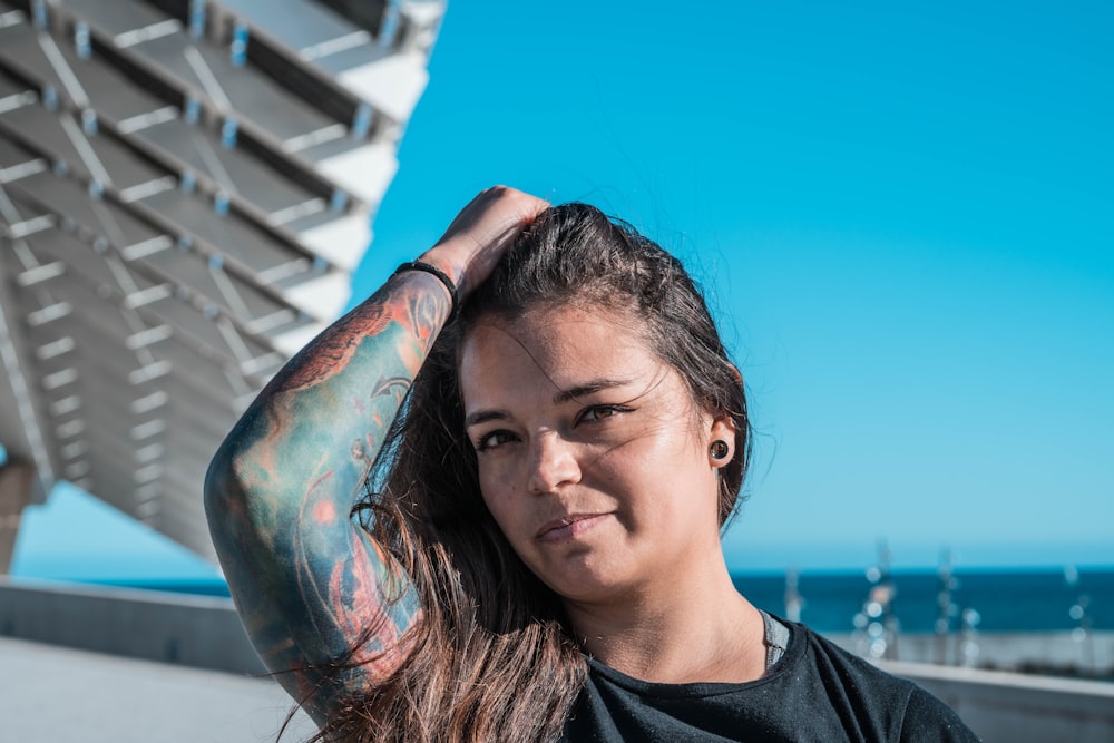 woman in black crew neck shirt with blue and white paint on her face