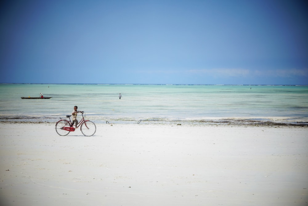 person holding white surfboard on beach during daytime