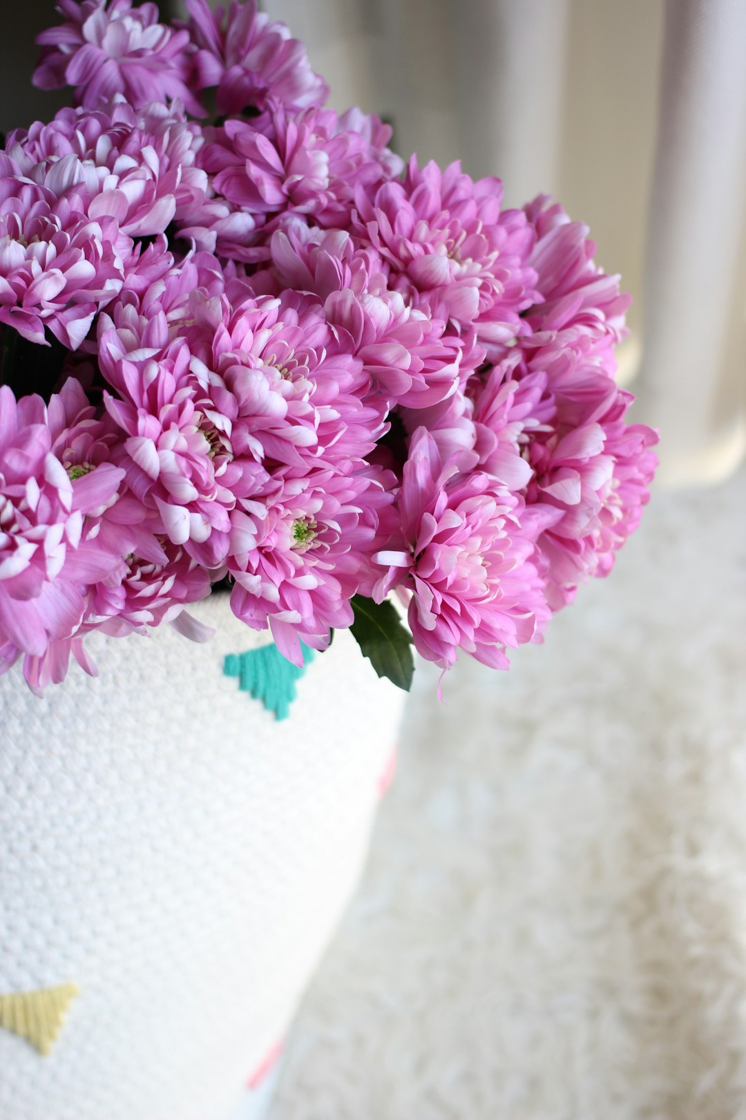 purple flowers on white vase