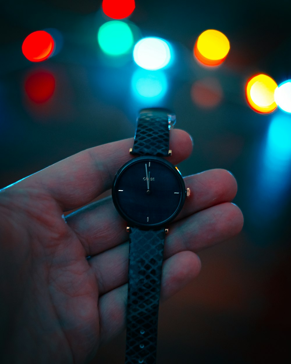 person holding black analog watch