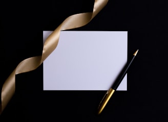 black and gold pen on white paper