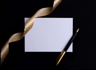 black and gold pen on white paper