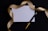 A blank white card surrounded by a luxurious gold ribbon on a dark background. A black and gold pen is placed beside the card, adding a touch of elegance.