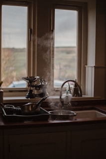 stainless steel teapot on black table