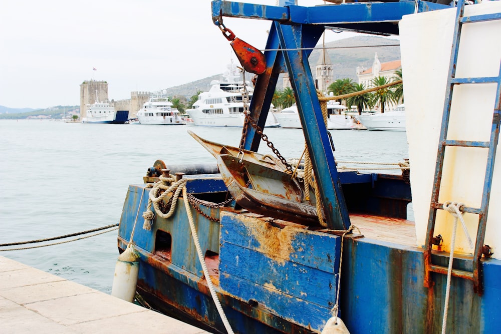 blue and brown boat on dock during daytime