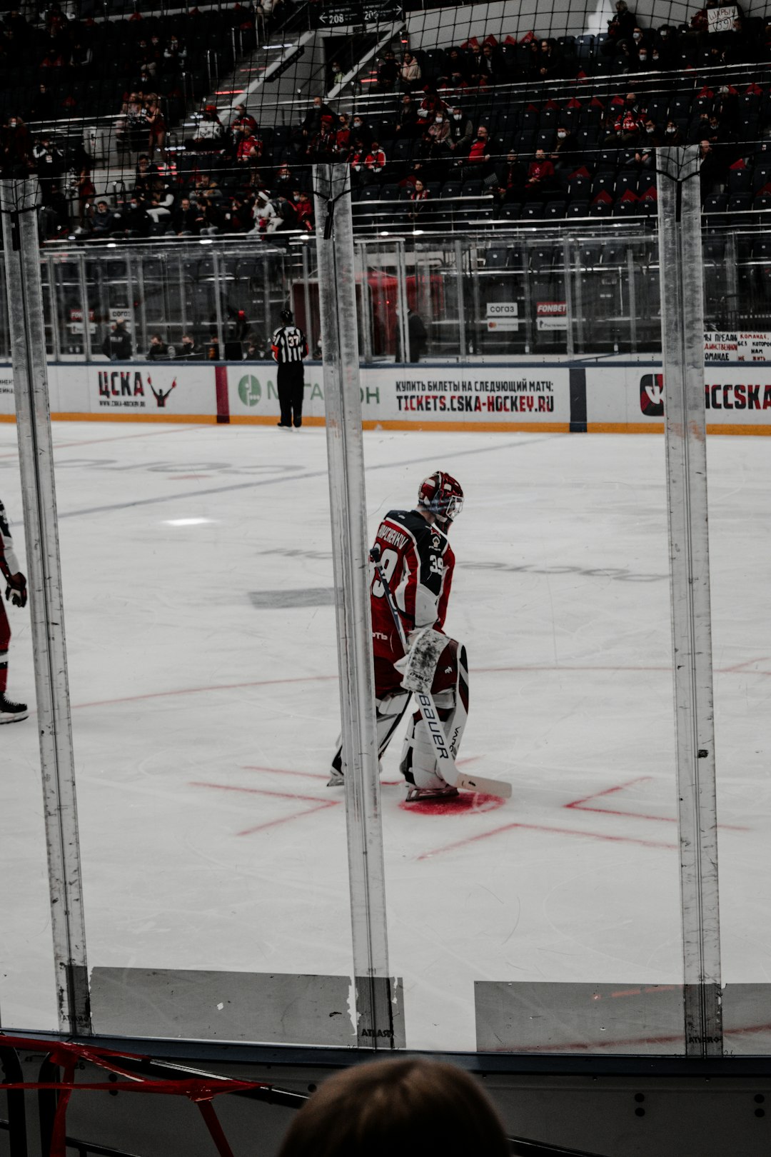 man in red and white ice hockey jersey playing hockey