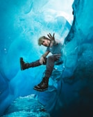 man in black and white striped shirt and blue denim jeans floating on water