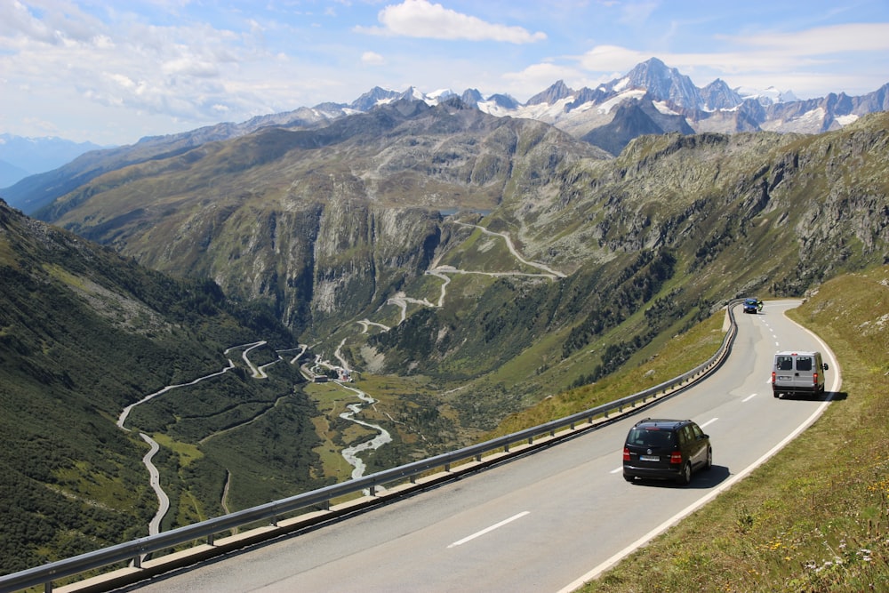 black car on road near mountain during daytime