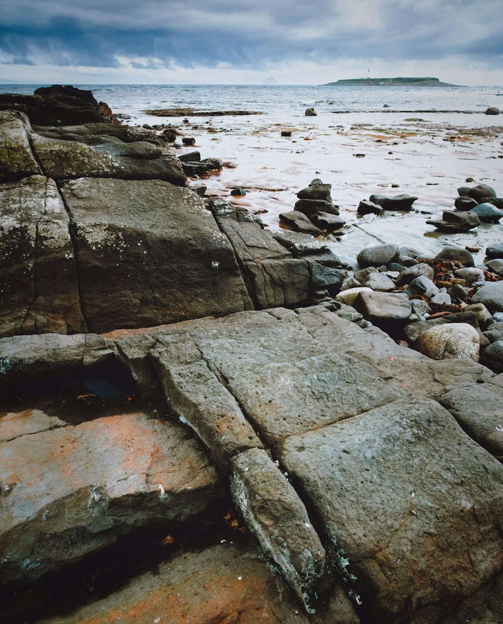 brown rock formation near sea during daytime