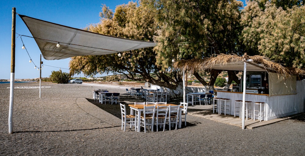 white table and chairs under blue sky during daytime