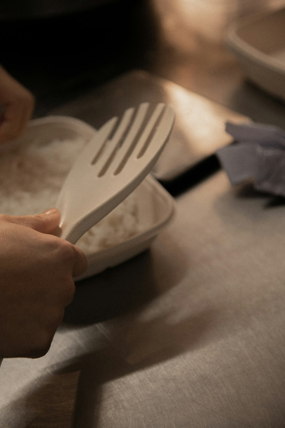 person holding white plastic fork