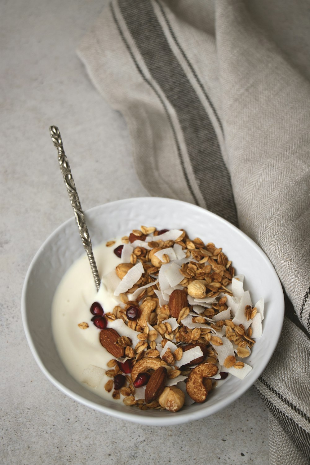 a bowl of yogurt and granola with a spoon