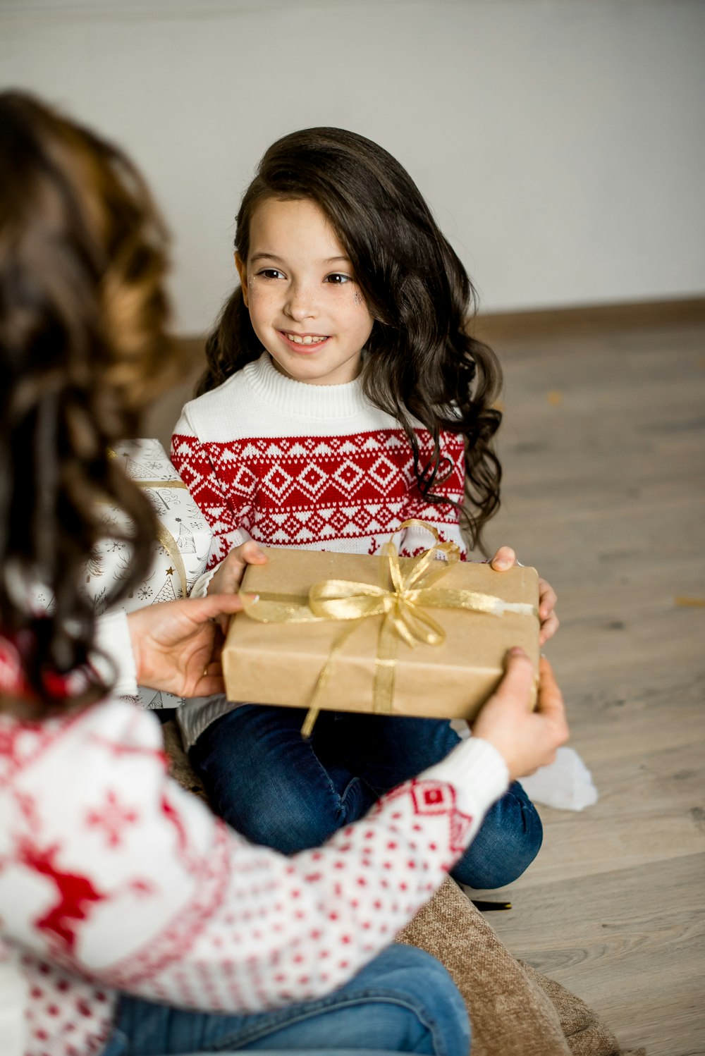 girl in red and white sweater holding brown box