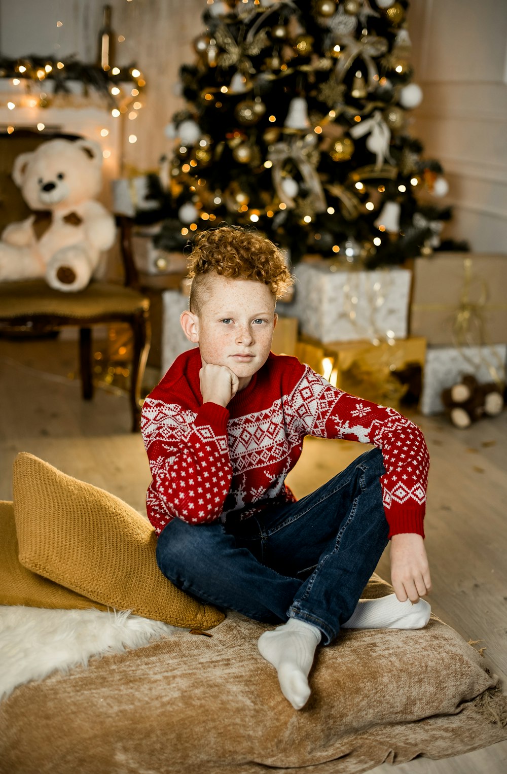 boy in red and white polka dots long sleeve shirt sitting on brown sofa chair