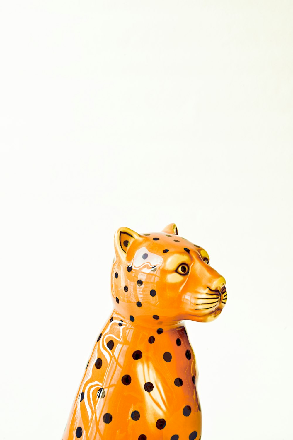 brown and black polka dot cat figurine