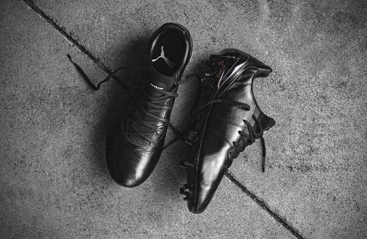 Bold red and black sneakers reflecting how football boot colourways are influencing everyday sneaker design