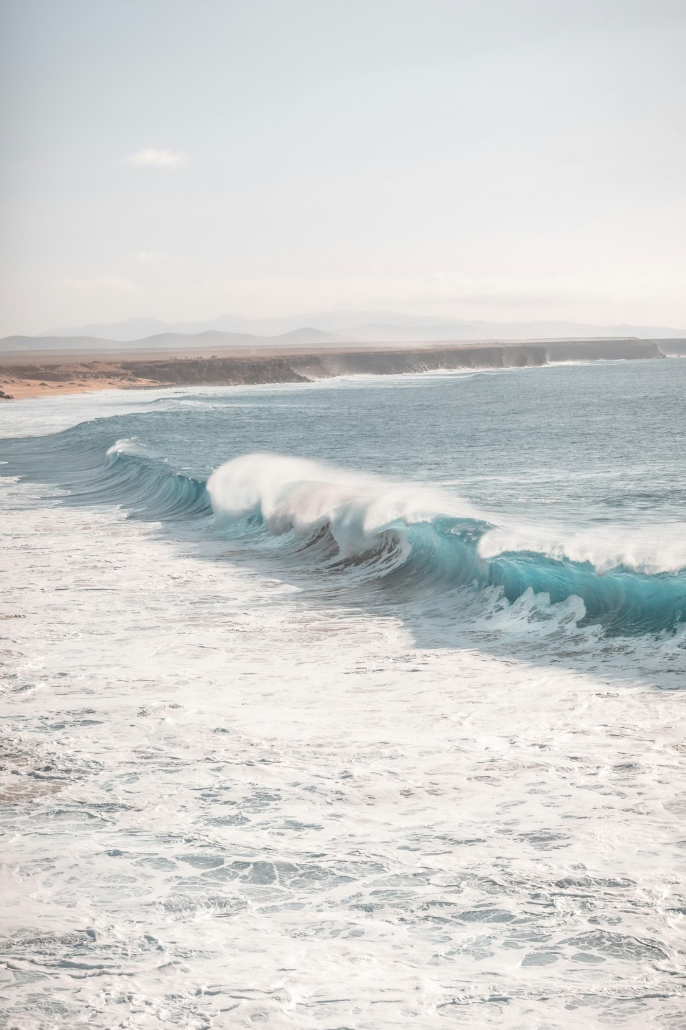 ocean waves crashing on shore during daytime