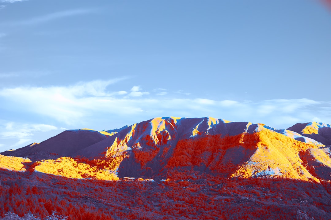 brown and white mountain under blue sky during daytime