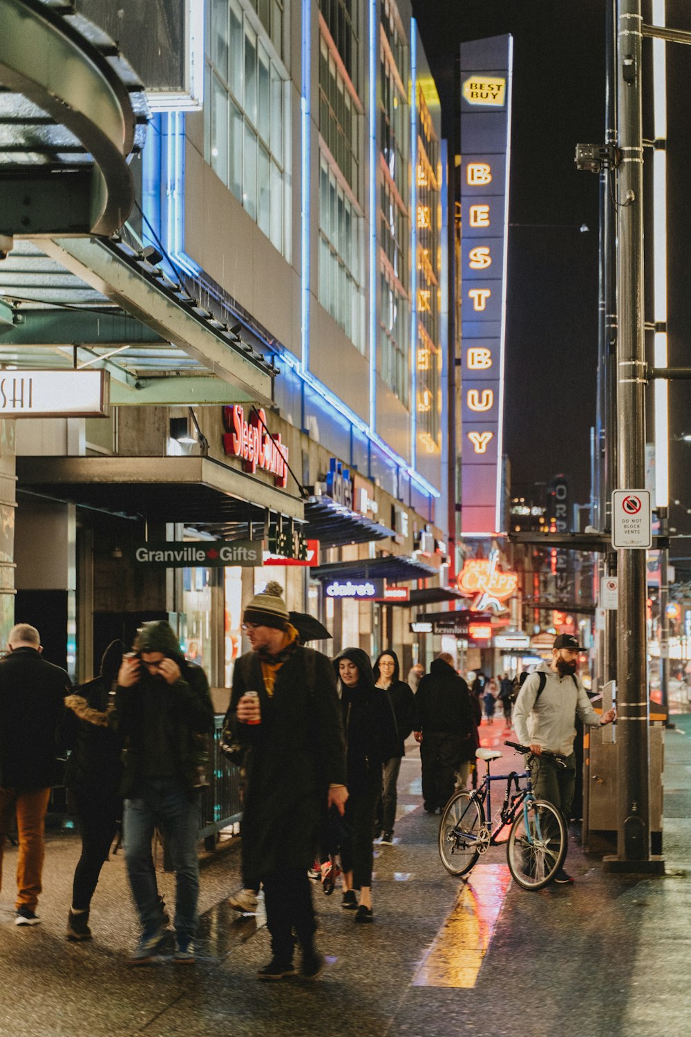 people walking on street during nighttime