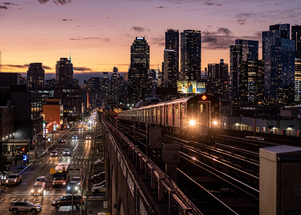 Queens, NY at nighttime with a train going by