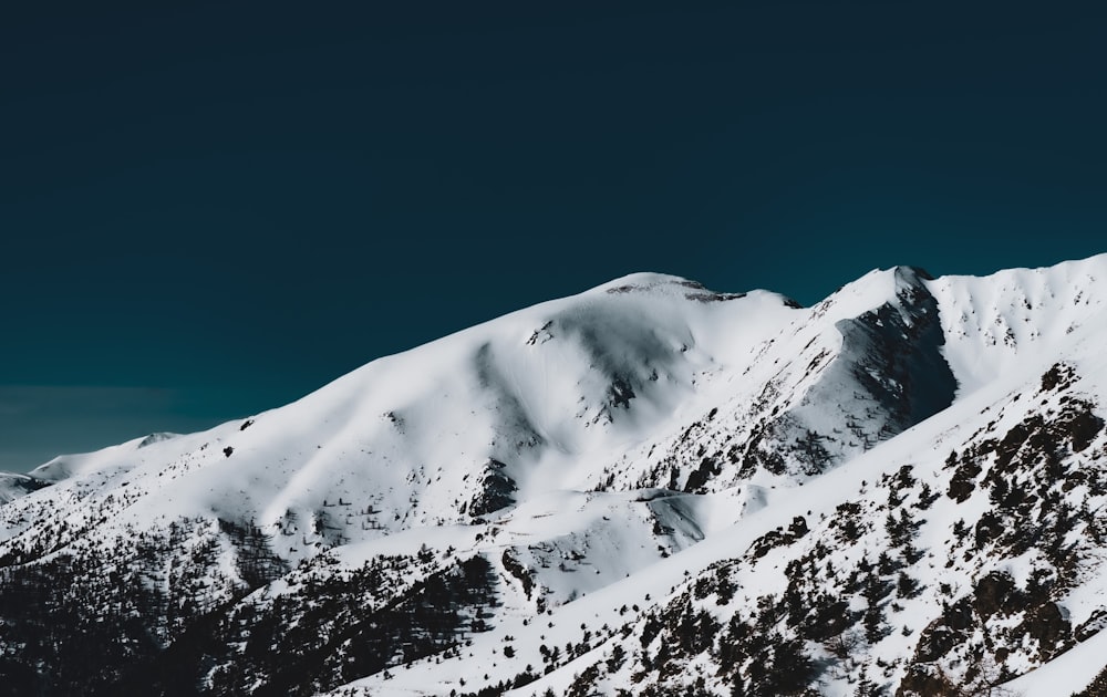 snow covered mountain under blue sky during daytime