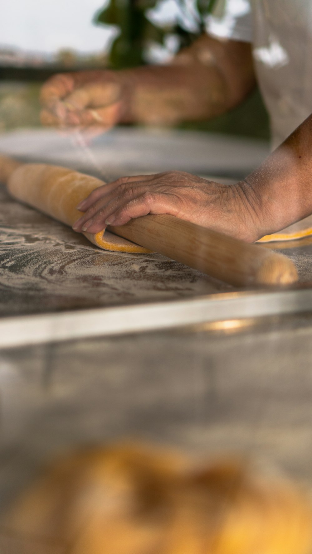 persons hand on brown wooden table