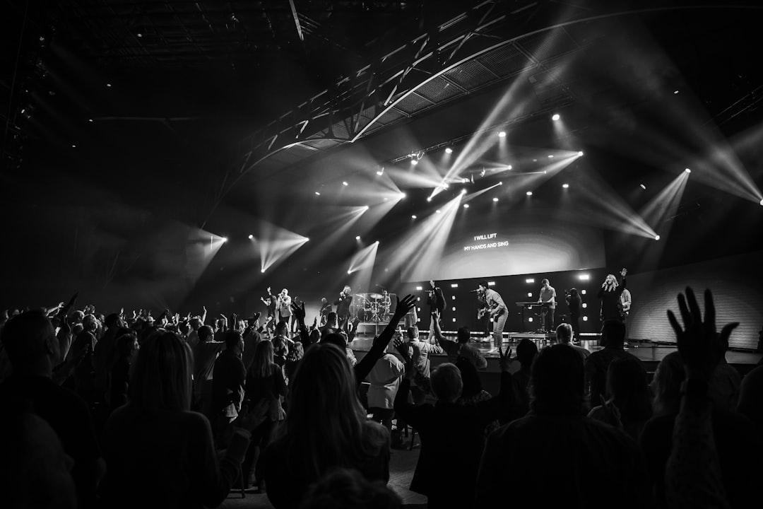 grayscale photo of people standing on stage