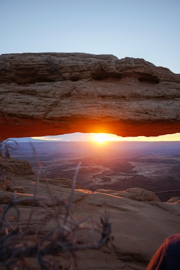 Sunset view over the ancient rock formations of AlUla, casting warm golden hues.