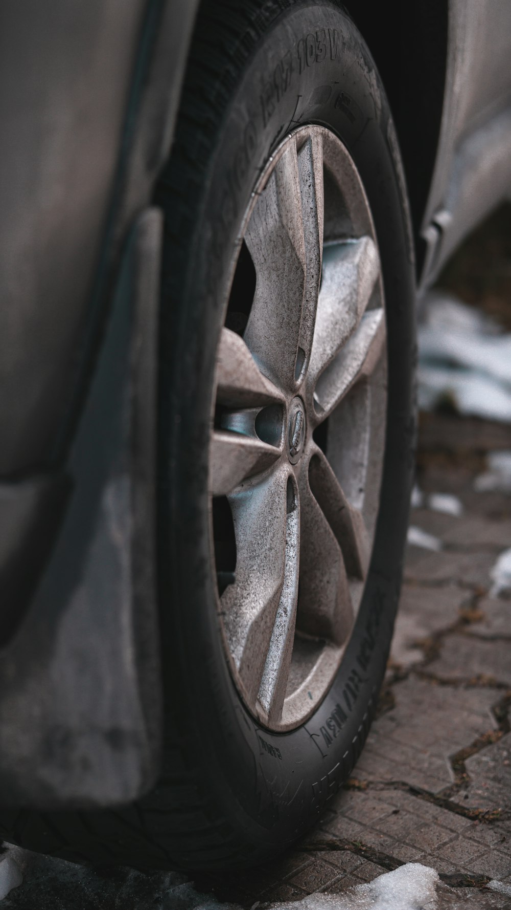 black car wheel on brown concrete floor